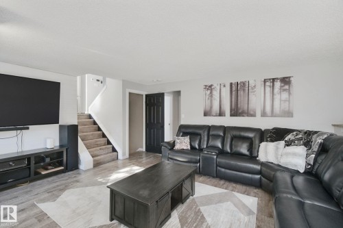 Wood-finish flooring throughout, paired with light gray walls - 38 Menalta Place, Cardiff, AB 