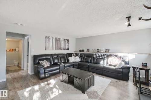Wood-finish flooring with a light gray wall color - 38 Menalta Place, Cardiff, AB 