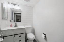 Vanity with barn door-style cabinetry, undermount sink, and matte black faucet - 