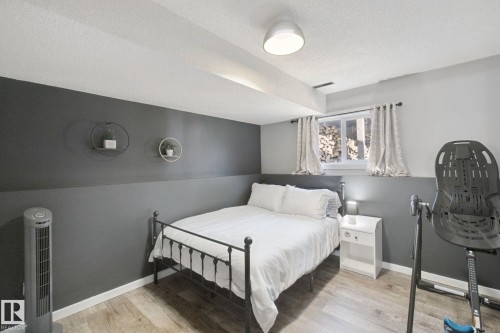 Wood-finish flooring, recessed window, and white trim - 38 Menalta Place, Cardiff, AB 