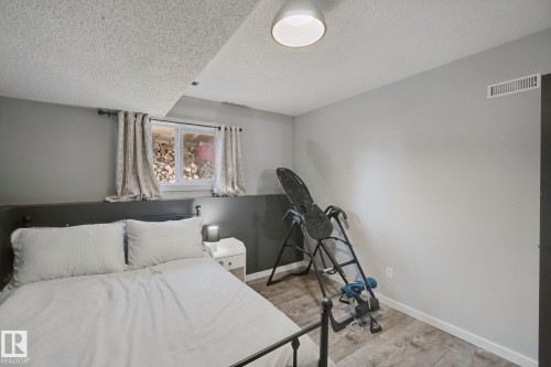 Wood-finish flooring with white trim and a neutral color palette - 38 Menalta Place, Cardiff, AB 