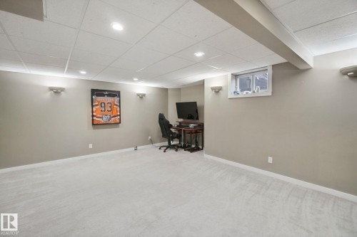 Recessed lighting, wall sconces, drop ceiling, light-colored carpeting, and a window - 38 Menalta Place, Cardiff, AB 