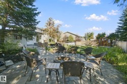 Expansive paver patio with a built-in fire pit - 