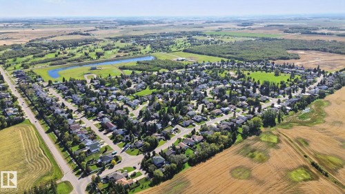 Aerial perspective showcasing residential properties within a developed neighborhood - 38 Menalta Place, Cardiff, AB 