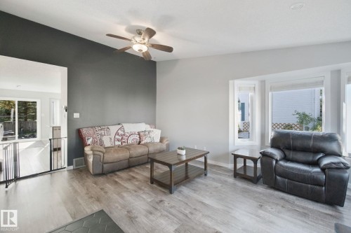 Wood-finish flooring, recessed lighting, ceiling fan light fixture, bay window, and a partial height wall - 38 Menalta Place, Cardiff, AB 