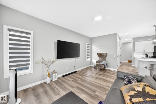 Recessed ceiling lighting, durable wood-finish flooring, and white trim throughout - 2415 194 Street Nw, Edmonton, AB 