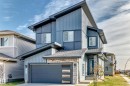 Contemporary exterior with multi-toned siding, stone veneer accents, an attached garage, and a covered front entry - 2415 194 Street Nw, Edmonton, AB 