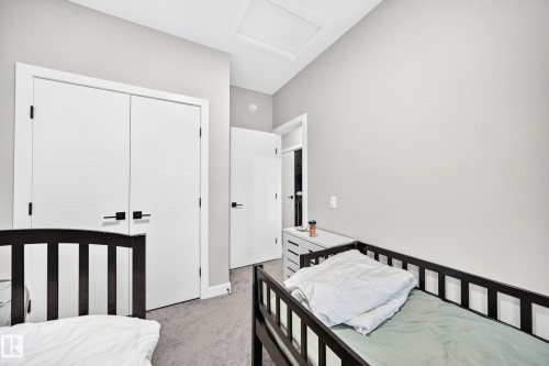 Vaulted ceiling, light gray wall paint, and double white doors with black hardware - 2415 194 Street Nw, Edmonton, AB 