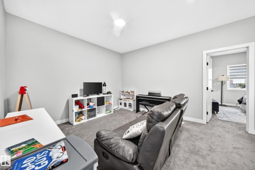 Carpeted room with light gray walls, a white door frame, and a ceiling fan - 2415 194 Street Nw, Edmonton, AB 