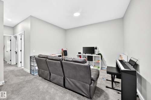Carpeted room with light gray walls, an overhead recessed light, and white trim - 2415 194 Street Nw, Edmonton, AB 