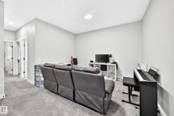Carpeted room with light gray walls, an overhead recessed light, and white trim - 