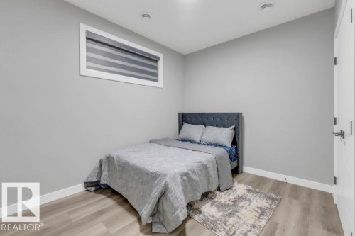 Recessed lighting, wood-finish flooring, and a horizontal window with blinds - 2415 194 Street Nw, Edmonton, AB 