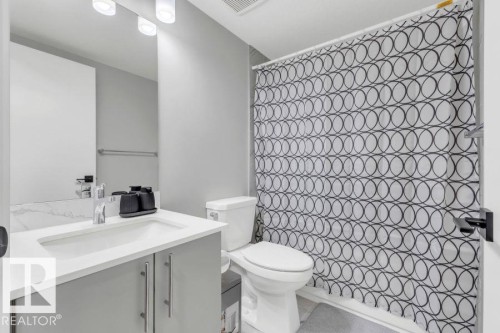 Vanity with integrated sink, chrome faucet, and gray cabinetry - 2415 194 Street Nw, Edmonton, AB 
