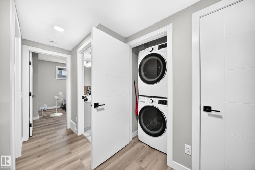 Integrated laundry closet with stacked washer and dryer - 2415 194 Street Nw, Edmonton, AB 