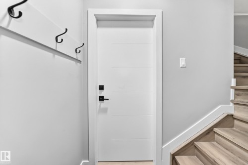 White interior door with horizontal paneling and matte black hardware - 2415 194 Street Nw, Edmonton, AB 