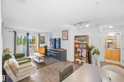 Wood-finish flooring throughout the living space - #203 245 Edwards Dr Sw, Edmonton, AB 