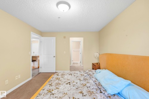 Textured ceiling with a flush-mount light fixture - #203 245 Edwards Dr Sw, Edmonton, AB 