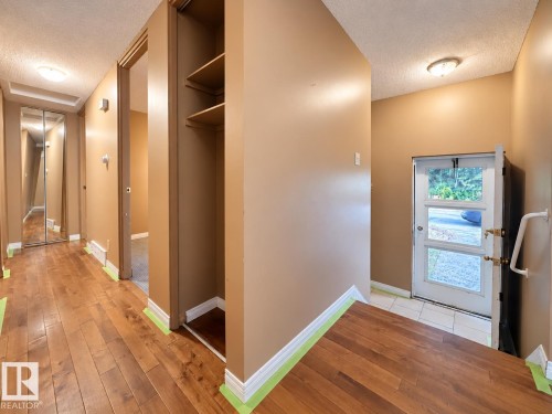Wood-finish flooring throughout the hallway - 12204 40 Avenue Nw, Edmonton, AB 