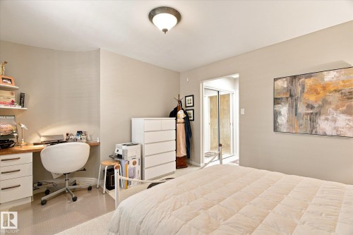 Built-in desk with wood-finish countertop and white cabinetry - 13862 Ravine Drive Nw, Edmonton, AB 