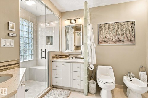 Glass-enclosed shower with a built-in bench and glass block wall - 13862 Ravine Drive Nw, Edmonton, AB 