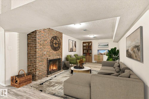 Brick fireplace with hearth, wood-finish flooring, recessed lighting, and built-in shelving - 13862 Ravine Drive Nw, Edmonton, AB 