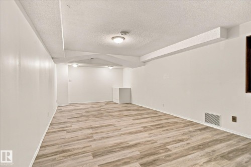 Light wood-finish flooring with white walls and ceiling - 13862 Ravine Drive Nw, Edmonton, AB 