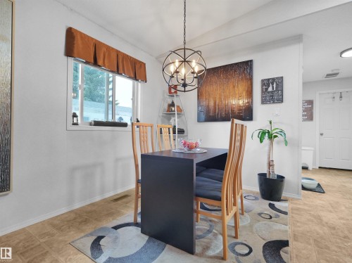 Wood-finish flooring, white walls, and a contemporary spherical chandelier - 52 Evergreen Park Northwest, Edmonton, AB 