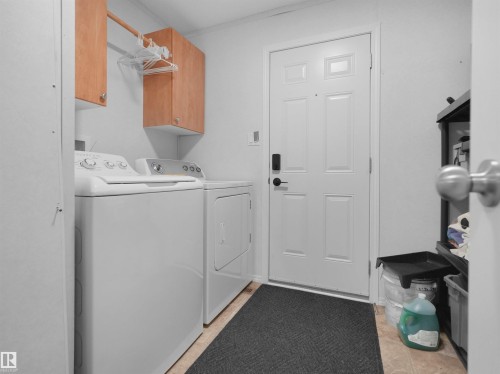 Laundry area with wood-finish upper cabinetry and a hanging rod - 52 Evergreen Park Northwest, Edmonton, AB 