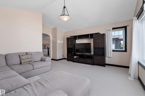 Vaulted ceiling, recessed lighting, arched doorway, expansive window, built-in entertainment unit - 11515 16 Avenue Sw, Edmonton, AB 