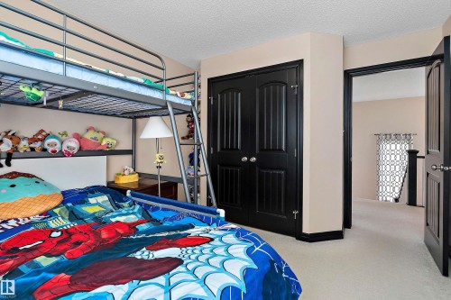 Neutral tone wall color, black paneled doors, and light-colored carpeting - 11515 16 Avenue Sw, Edmonton, AB 