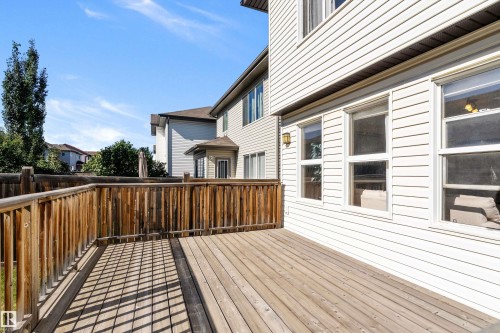 Expansive outdoor deck with natural wood planks and a matching railing - 11515 16 Avenue Sw, Edmonton, AB 