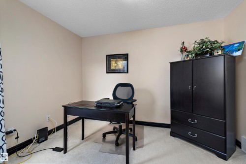 Carpeted flooring, neutral wall color, and dark trim - 11515 16 Avenue Sw, Edmonton, AB 