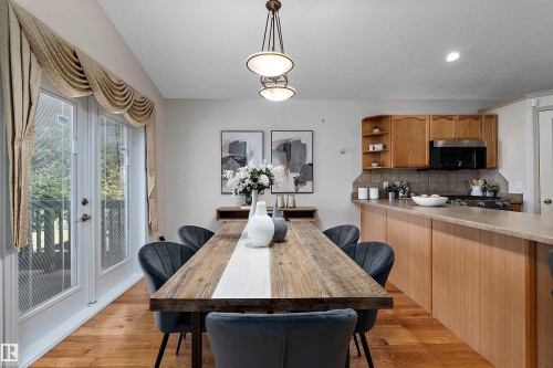Hardwood flooring, kitchen with wood cabinetry, and double French doors - 1046 Blackburn Close Sw, Edmonton, AB 