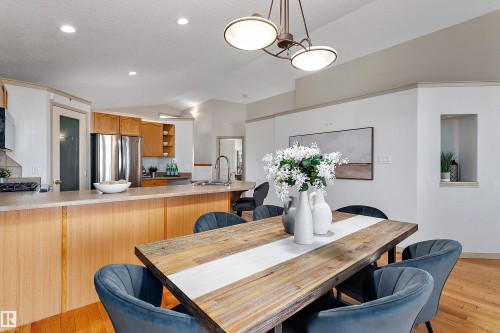 Vaulted ceilings, recessed lighting, wood-finish flooring, built-in kitchen cabinetry, and a built-in kitchen island - 1046 Blackburn Close Sw, Edmonton, AB 
