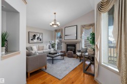 Vaulted ceilings, hardwood flooring, fireplace, recessed wall niche, and chandelier - 