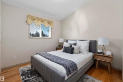Hardwood flooring, crisp white walls, single window with blinds, vaulted ceiling, and recessed lighting - 