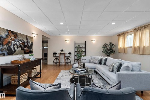 Recessed lighting, wood-finish flooring, and sconce lighting - 1046 Blackburn Close Sw, Edmonton, AB 
