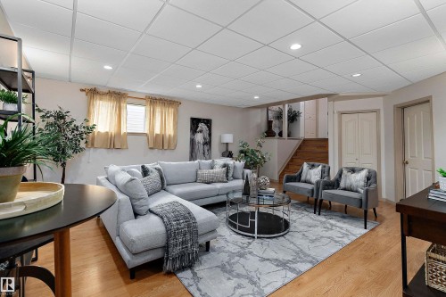 Recessed lighting illuminates the space, featuring a drop ceiling and wood-finish flooring - 1046 Blackburn Close Sw, Edmonton, AB 