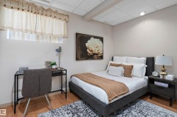 Wood-finish flooring, drop ceiling with recessed lighting, and neutral wall paint - 