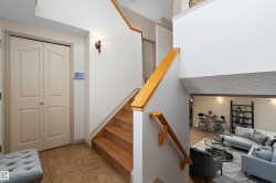 Wood-finish staircase with natural wood handrail - 