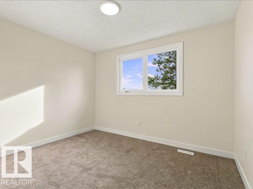 Neutral wall paint, plush carpeting, white trim, and a flush-mount ceiling light fixture - 18325 66 Avenue Nw, Edmonton, AB 