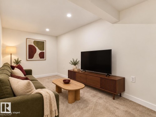 Recessed ceiling lighting, light-toned carpeting, white walls, and an exposed ceiling beam - 18325 66 Avenue Nw, Edmonton, AB 