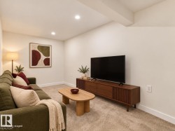 Recessed ceiling lighting, light-toned carpeting, white walls, and an exposed ceiling beam - 