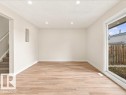 Recessed lighting, wood-finish flooring, white walls, sliding glass door, and a built-in wall niche - 18325 66 Avenue Nw, Edmonton, AB 