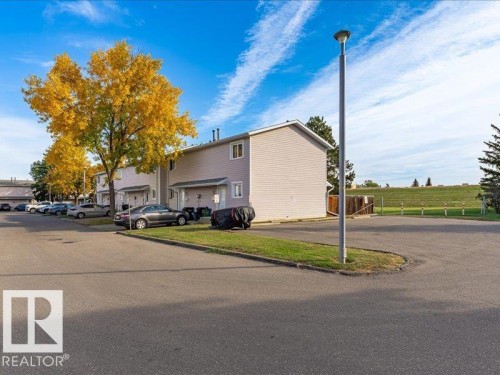 Two-story residential structures featuring light-colored siding - 18325 66 Avenue Nw, Edmonton, AB 