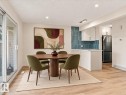 Sliding glass door, wood-finish flooring, recessed lighting, white cabinetry, and a textured tile backsplash - 18325 66 Avenue Nw, Edmonton, AB 