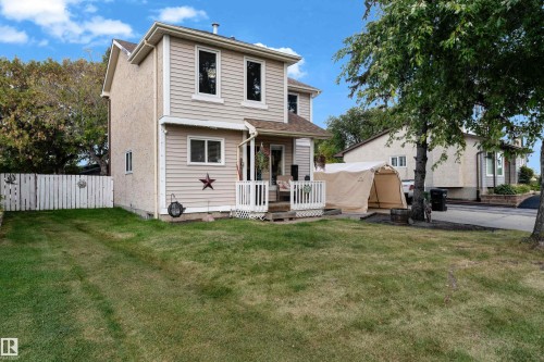 Two-story residence featuring light-colored siding and stucco exterior finishes - 1920 145 Avenue Nw, Edmonton, AB 