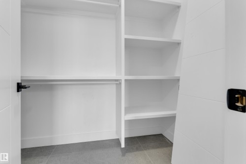 Custom built-in closet system featuring shelving and hanging rods - 512 Robinson Boulevard, Leduc, AB 