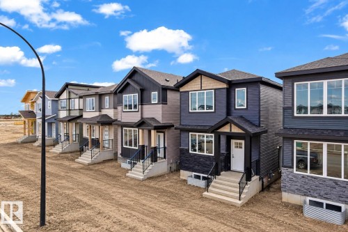 Multiple newly constructed residences featuring varied exterior finishes and covered entryways - 512 Robinson Boulevard, Leduc, AB 