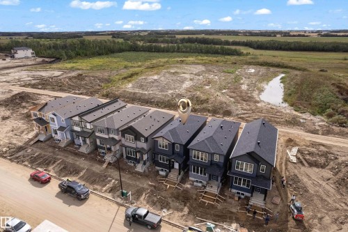 Newly constructed properties featuring multi-level designs and dark shingle roofs - 512 Robinson Boulevard, Leduc, AB 
